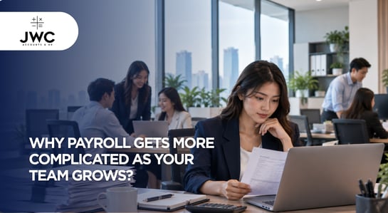 Singapore SME payroll manager reviewing employee payroll records as the business team grows