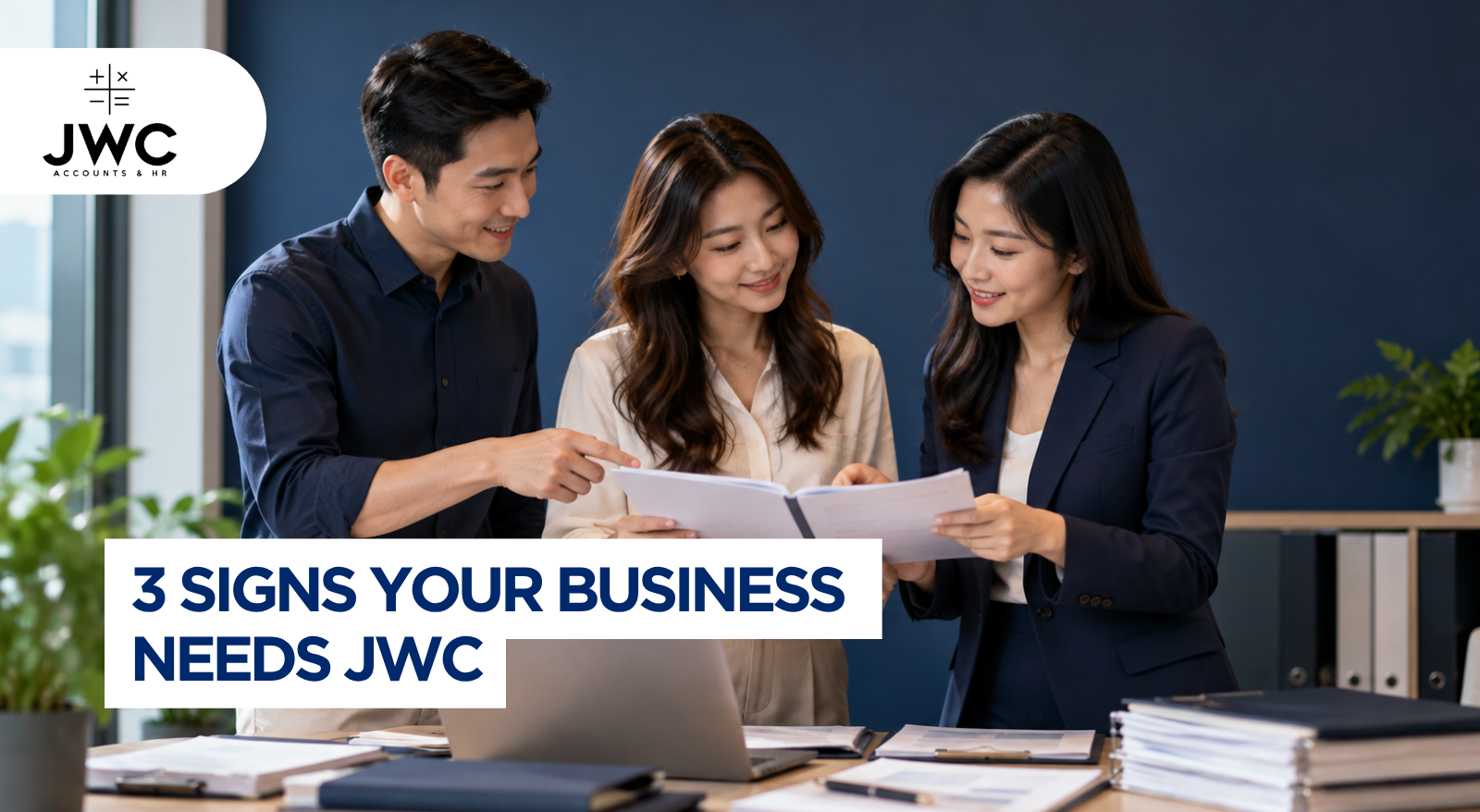 Singapore SME business owner reviewing an accounting backlog and financial documents at a desk